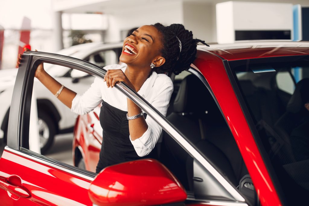 Stylish black woman in a car salon