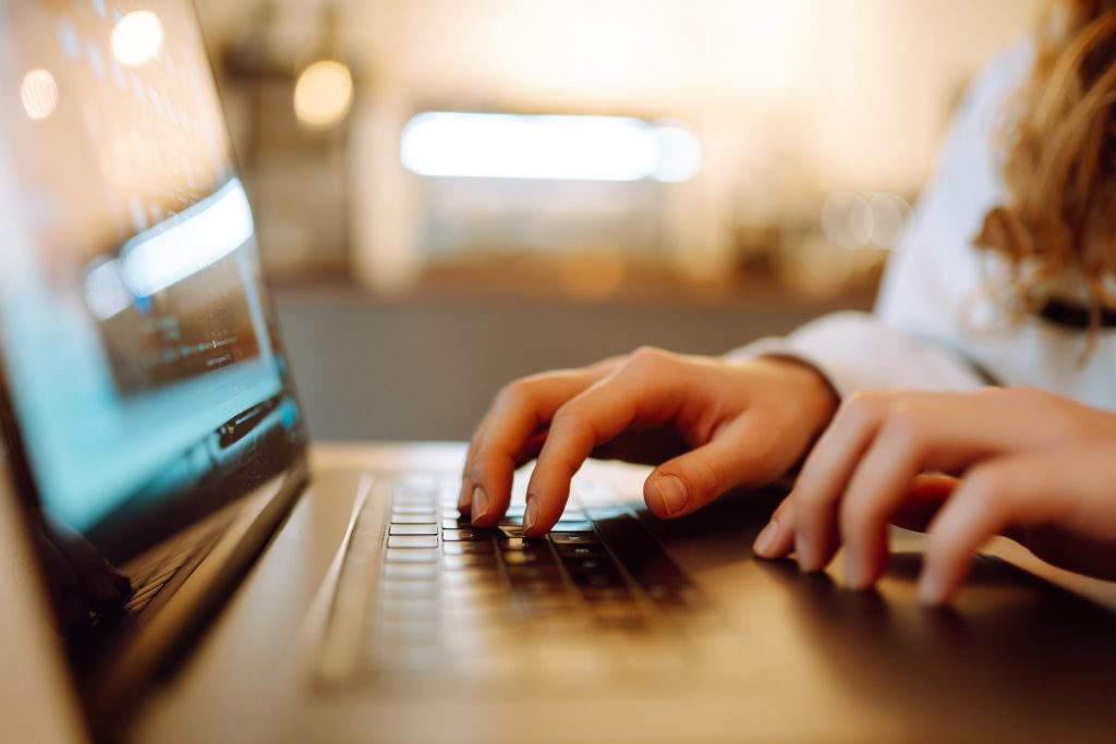 Female hands working on a laptop, close-up. Technology, Freelanc