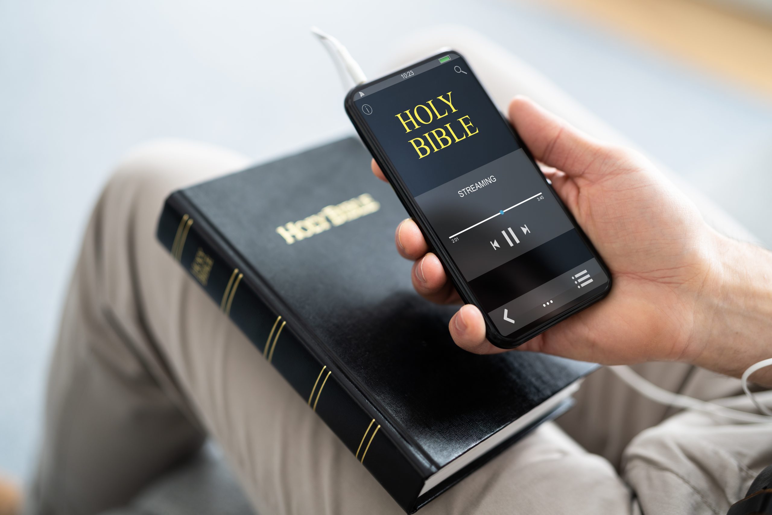 Person Listening Bible On Phone.