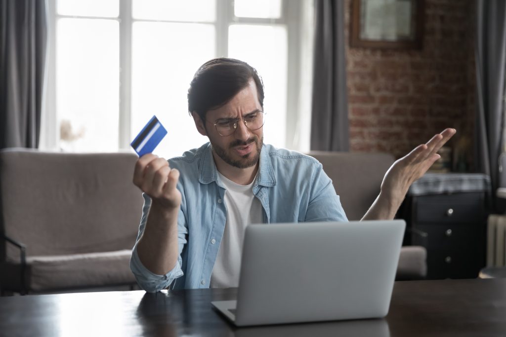 Annoyed frustrated bank customer man using laptop, reading message