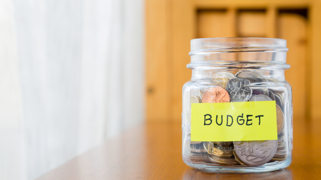 glass jar labeled "budget" with money inside