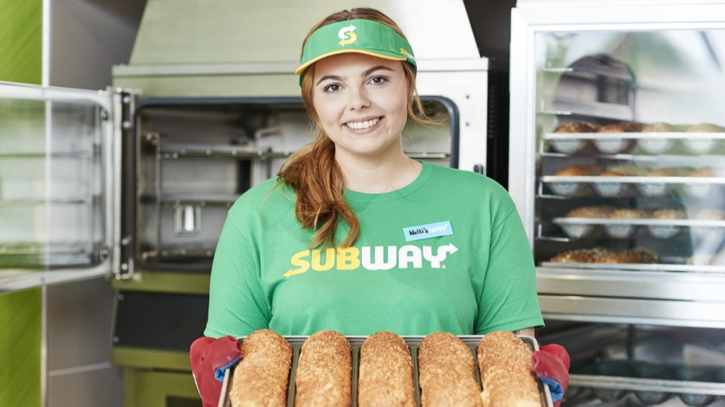 Subway female employee smiling