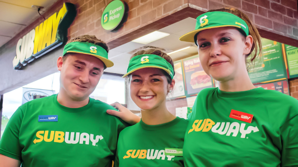 Subway employees smiling