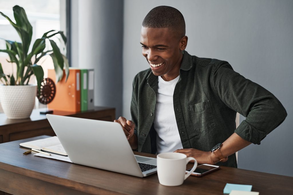 I shouldve been working from home all along. Shot of a young businessman using his laptop while working from home.