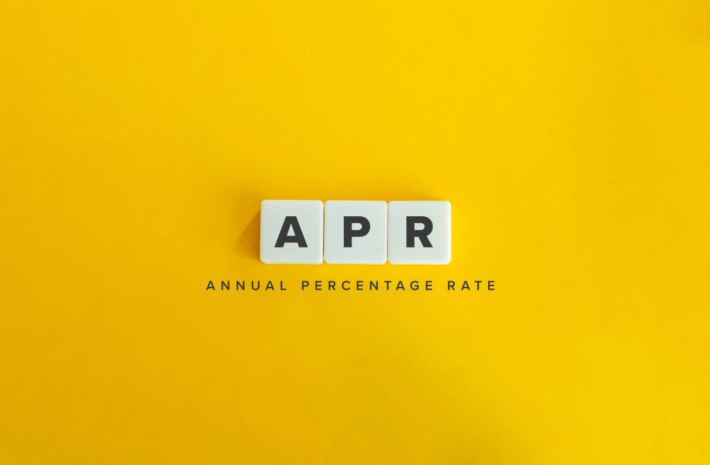 Annual Percentage Rate (APR) Banner. Letter Tiles on Yellow Background. Minimal Aesthetics.