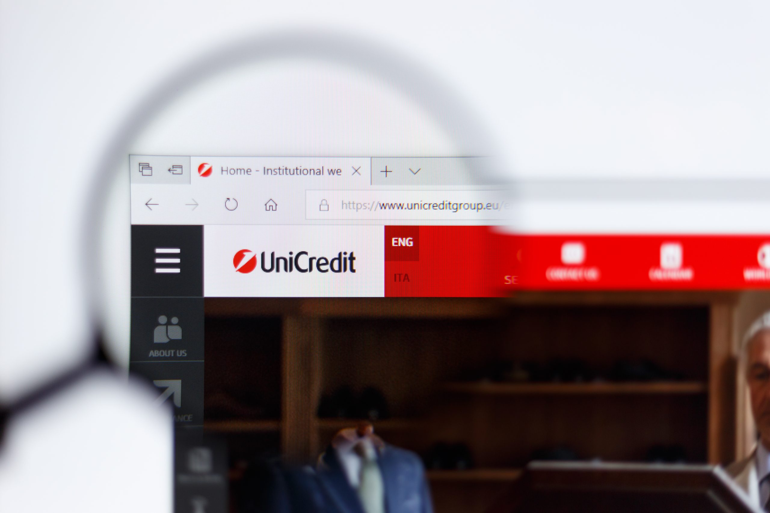 Moscow / Russia - 04.08.2019: UniCredit logo on the official website homepage. UniCredit logo visible on monitor screen through a magnifying glass