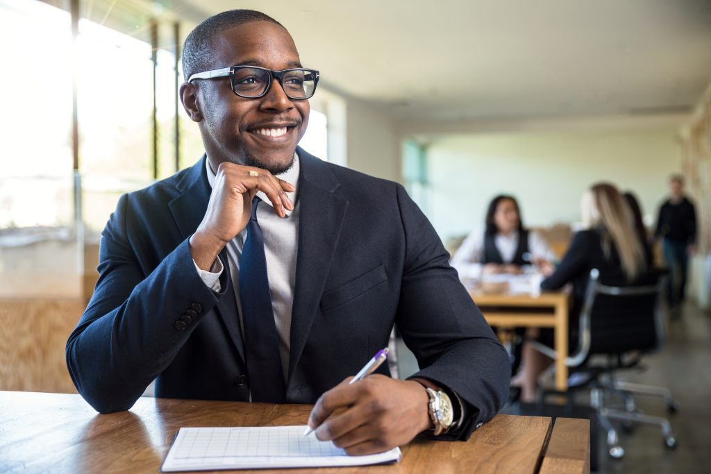 Attentive enthusiastic new hire career worker taking notes listening with nice smile